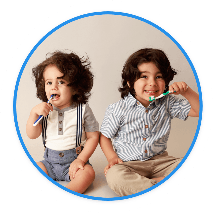 Young boy with glasses holding fake mustache on a stick