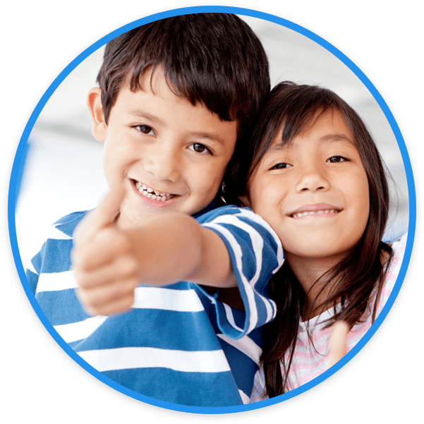 Young boy giving thumbs up with smiling girl next to him